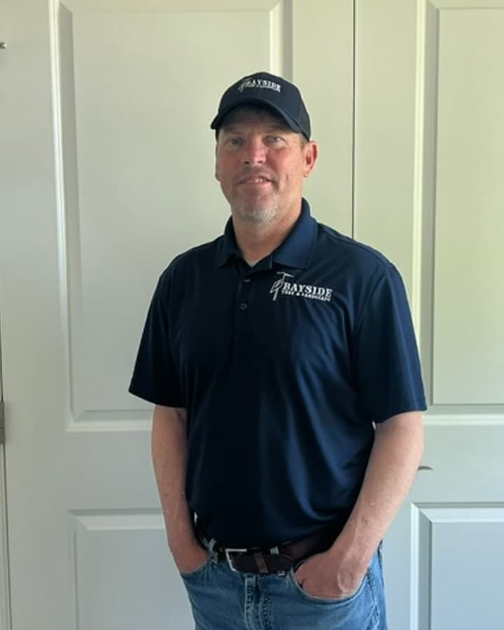 Craig Stitcher, owner of Bayside Tree and Landscape, in branded company apparel